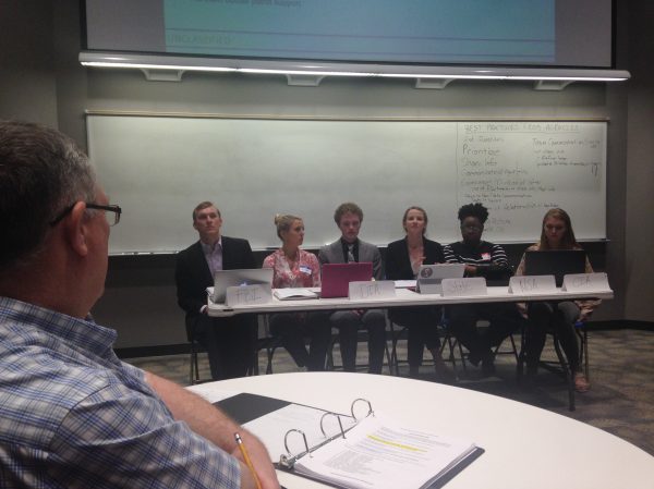 Panel of students at table